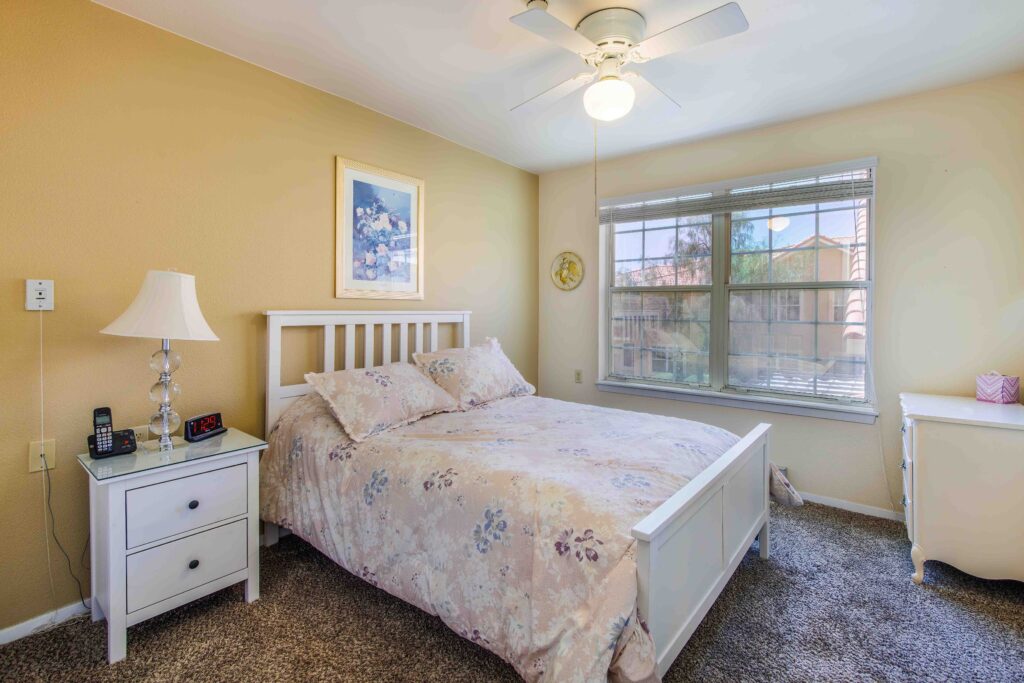 Interior image of a resident's bedroom with lots of natural sunlight at Vista Pointe at Lake Havasu City, a senior living community near Bullhead City.